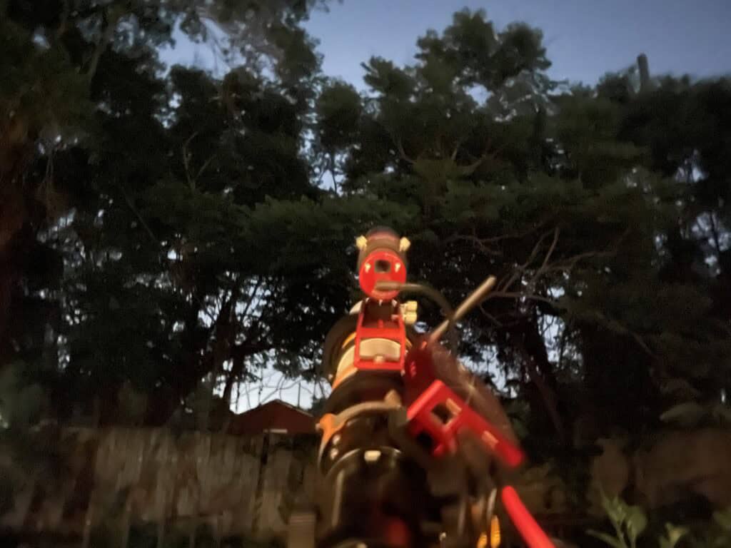 Telescope pointed toward a backyard sky completely blocked by trees