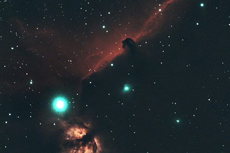 Horsehead and Flame Nebula through a dual-band filter, showing teal stars from a Bortle 9 sky